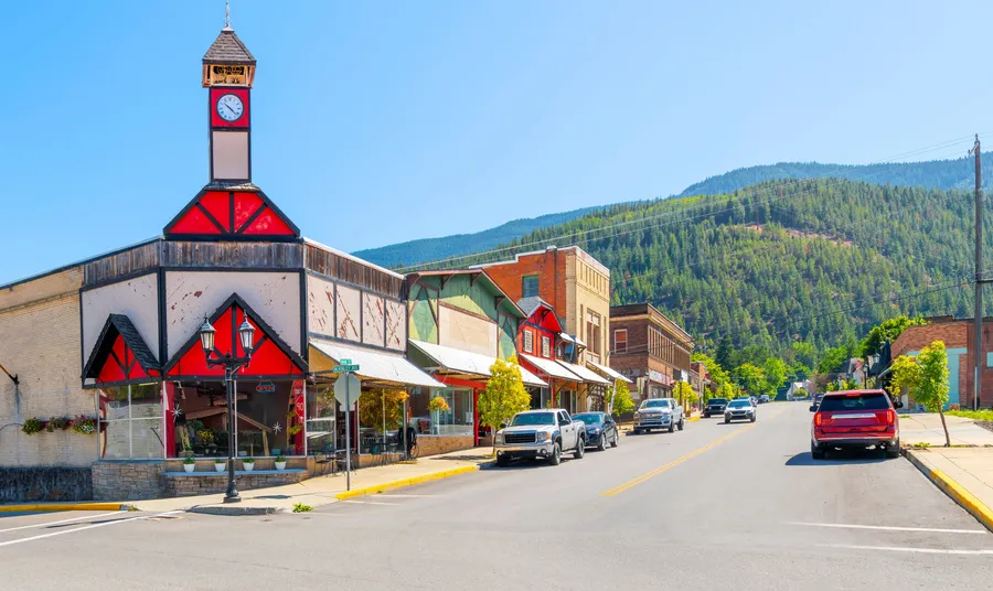 Historic downtown Kellogg, Idaho, with its landmark clock tower on Main Street and the Silver Valley mountains behind