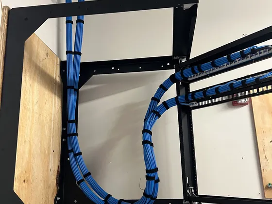 Structured network cabling neatly routed and labeled inside a wall-mounted equipment rack